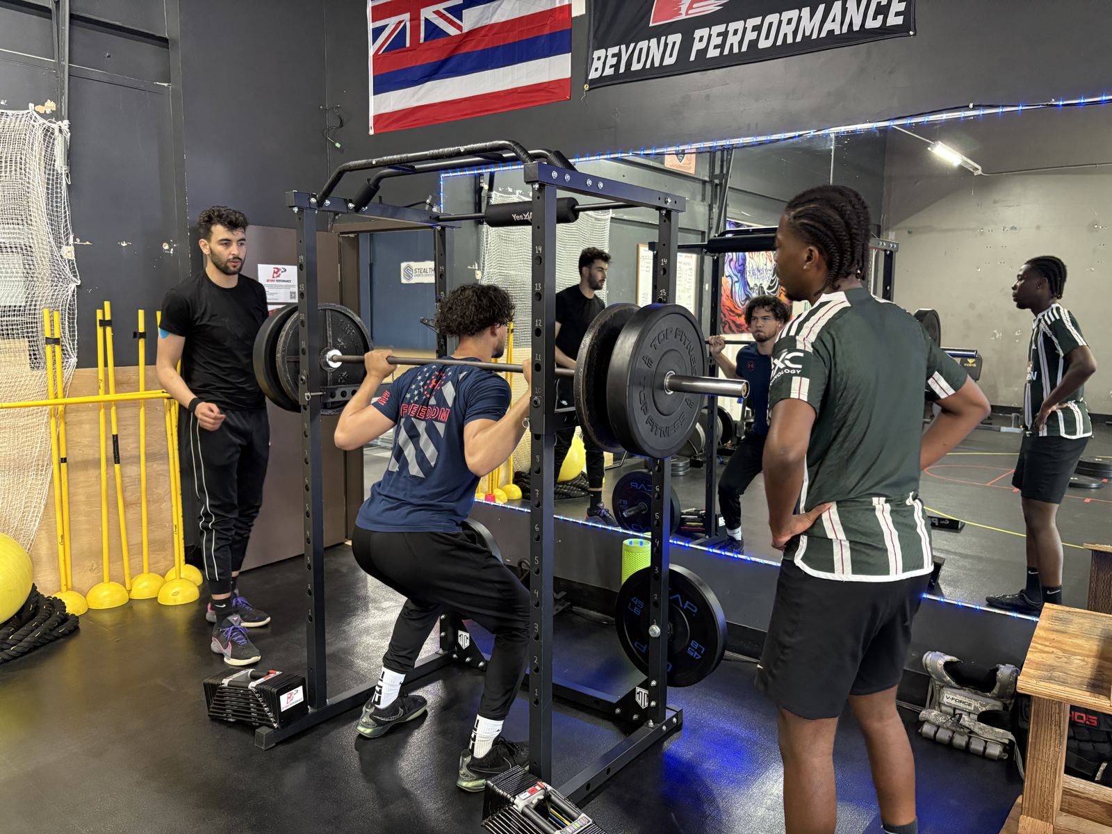 Coach watching an athlete squat