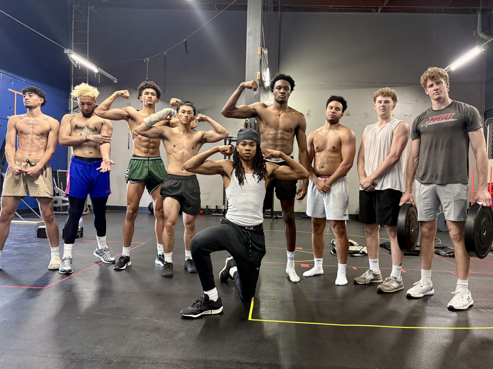 A team of athletes flexing after a training session